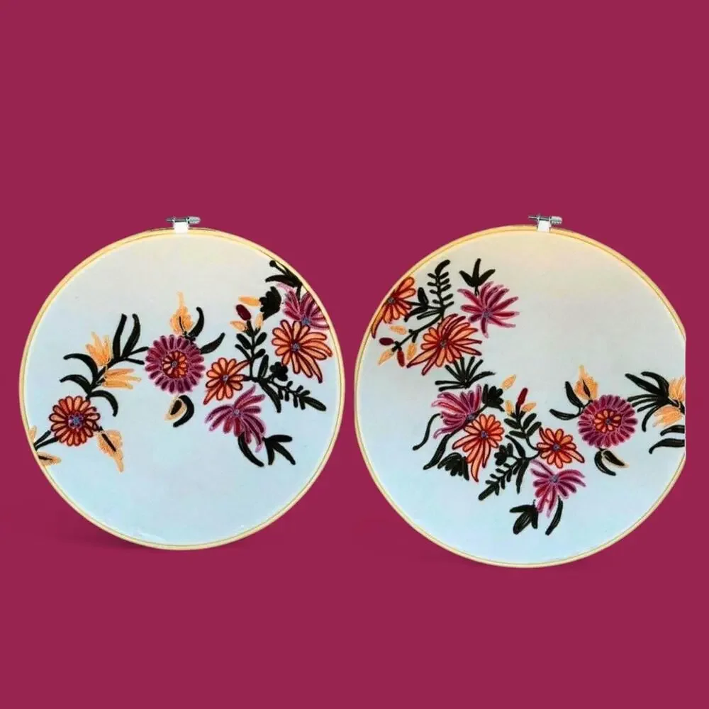 Set of two matching floral embroidered bamboo hoop art. 12” and 10.5”.